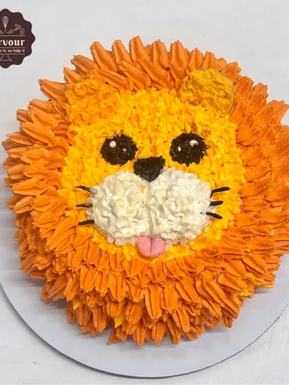 A cute and simple lion face cake, created entirely with piped whipped cream frosting. This design is a great example of how I can create character cakes with zero fondant.