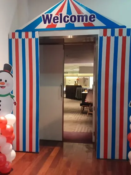 A custom-built carnival tent entranceway, complete with snowman and elephant props. This kind of immersive entrance makes guests feel like they are stepping into another world.