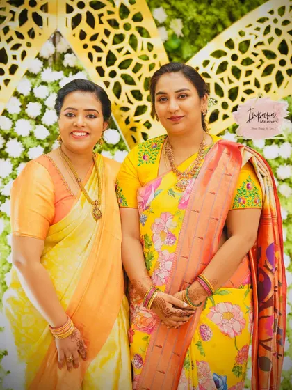 Beautiful sisters posing together at a reception. I provided makeovers for both, coordinating their looks while reflecting their individual styles.