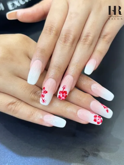An elegant and romantic design on long, square-tipped extensions. We started with a classic white-to-pink baby boomer ombre and added hand-painted red hibiscus flowers for a pop of color.