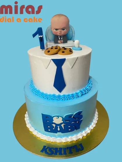 This two-tier Boss Baby cake means business. The design includes the signature suit and tie, a fondant Boss Baby topper, and fun details like cookies and a milk bottle for the little CEO's first birthday.