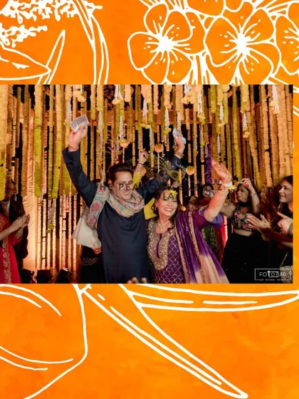 The happy couple celebrating during their Haldi ceremony, showering each other with flower petals under the traditional hanging marigold decor. These are the moments I love to help create.