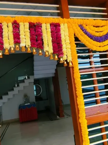 Another angle of a colorful floral door frame decoration. The design is dense and vibrant, making a strong first impression for any celebration.