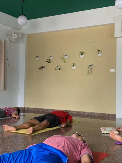 Our studio is a space for rest and rejuvenation. Here, students are in Savasana, a vital pose for integrating the practice and finding deep relaxation after their hard work.