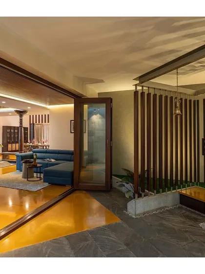 We designed this sacred worship space as a semi-open pavilion within the home. The wooden slats provide privacy while connecting the space to the adjoining landscaped area, creating a tranquil atmosphere for prayer.