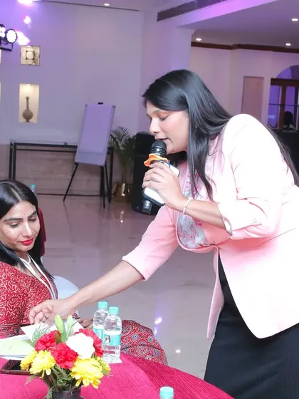 Getting up close with an attendee to hear her thoughts. I believe in making every person feel seen and valued, which is key to a successful and engaging event.