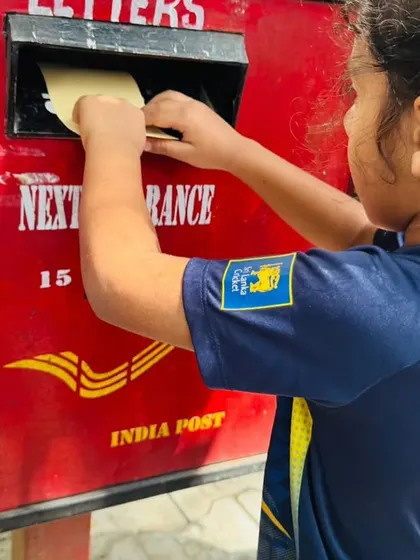 This child is excited to mail his letter, a memorable, real-world learning experience.