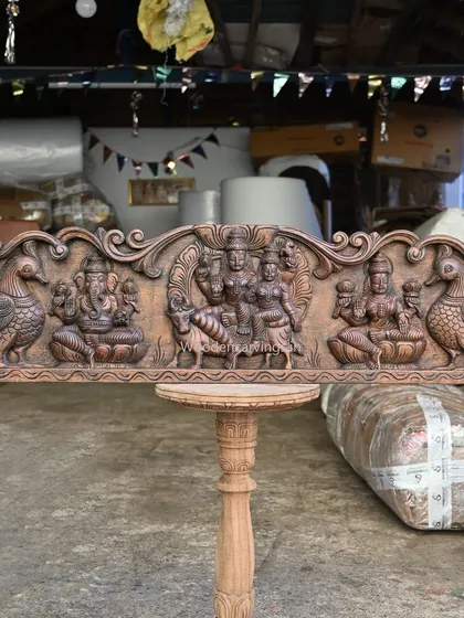 The full 42-inch panel featuring the divine family: Lord Shiva with Parvathi, Ganesha, and Lakshmi, all carved in a rich brown finish.