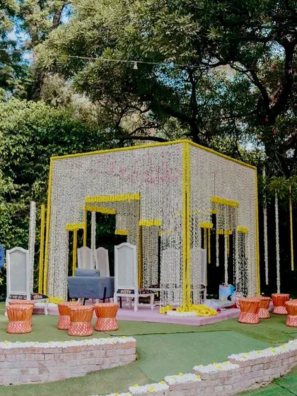 A stunning mandap created with strings of marigolds and tuberoses, showcasing a blend of tradition and modern design for a daytime wedding.