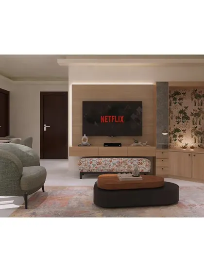 An overview of an open-plan living and dining area. The furniture arrangement, including the accent chair and patterned ottoman, helps define the lounge space while maintaining a sense of openness.