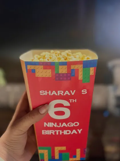 A personalized Ninjago-themed popcorn box, making movie time at the party extra special.