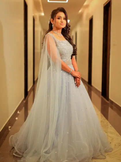 A full-length shot showcasing the flowing gown in a hotel corridor.