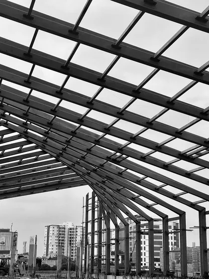 "Roof Likes To Swing": A series of black and white photos tracking the progress of a large-scale steel roof structure for an experience center in Chennai.