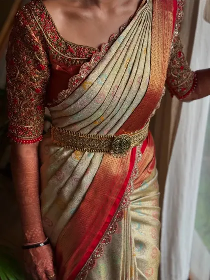 A beautiful example of a traditional South Indian Kanjeevaram saree drape, with perfect pleats and a classic belt.