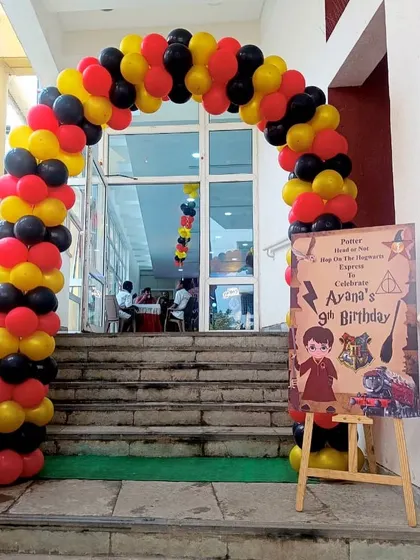 A grand entrance for a Harry Potter themed party. This balloon arch in house colors and a personalized welcome sign sets the magical mood right from the start.