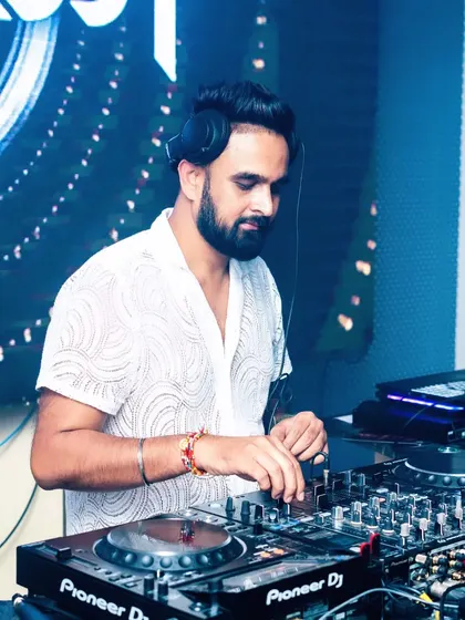 Another angle of me working the Pioneer DJ decks. This professional equipment allows me to be creative with my mixes and deliver a high-quality audio experience.