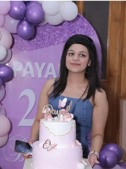 The birthday girl, Payal, with her beautiful custom cake that perfectly complements the purple and pink decor we created for her 21st birthday.