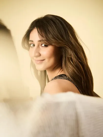 A gentle and beautiful portrait. The soft lighting and her warm smile create a truly lovely image.