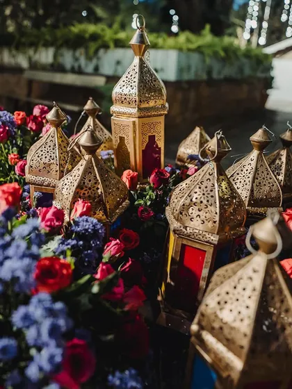 Intricate Moroccan lanterns are nestled within vibrant floral arrangements, a beautiful fusion of decor elements.