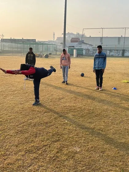 A player works on their balance and flexibility during a morning fitness session. These foundational elements are crucial for injury prevention and efficient movement on the field.
