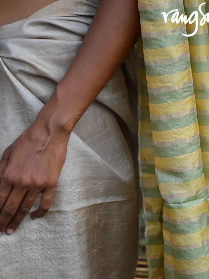 A close-up of the Genda Phool Kosa Silk Saree, showing the striped pallu and the rich texture of the silk. This is a perfect pick for lovers of classic handloom.