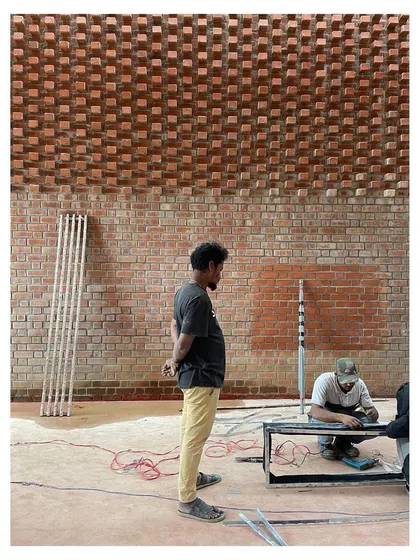 Duplicate of workers installing lighting.
