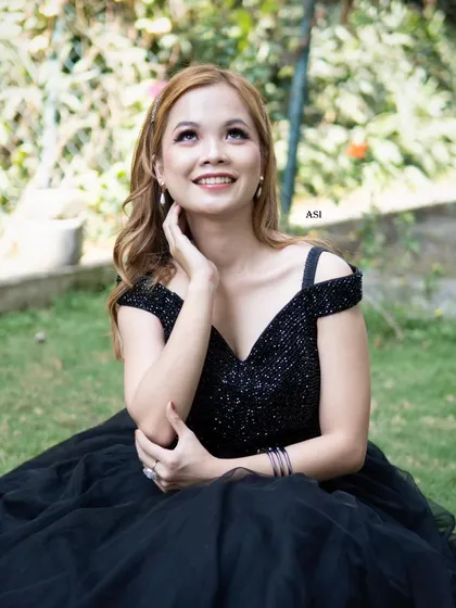 A close-up of our client looking radiant in the black ballgown. It's a timeless choice for any formal occasion.