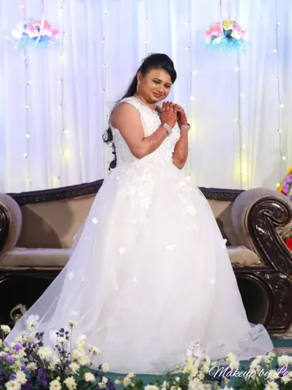 A beautiful Christian bride in her white wedding gown. I created a soft, romantic makeup look and an elegant hairstyle to complement her stunning dress for the reception.