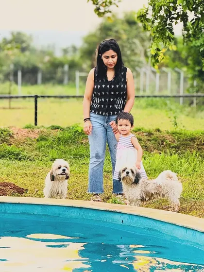 A family moment by the water's edge. Our pool is a popular spot for families to gather and watch their furry members play.