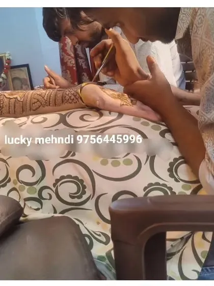 A close-up of me applying mehndi on a client's feet. Foot mehndi is an essential part of the complete bridal look, and I give it the same attention to detail.