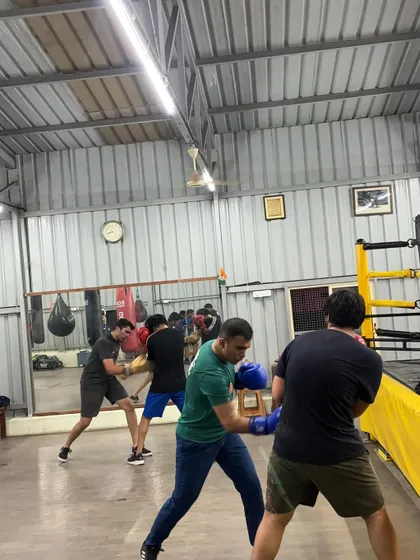 A group of members engaged in technical sparring drills. This kind of practice is essential for building a strong boxing foundation.