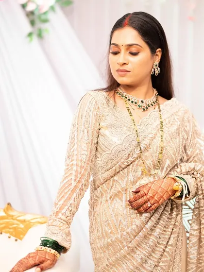 An elegant pose showing the full reception look. The makeup is subtle enough not to overpower her, yet polished enough for a formal evening event.