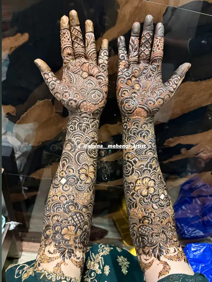 This design showcases a variety of patterns, from floral to geometric, creating a rich tapestry of henna art on the arms.