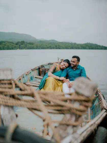 An intimate portrait of a couple on a rustic boat, capturing a quiet moment of connection.