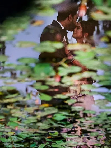 A unique reflection shot of the couple, creating an abstract and artistic wedding portrait that stands out.