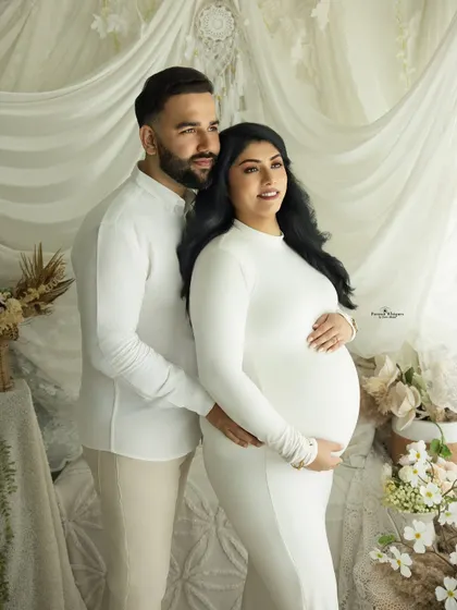 A hopeful and dreamy portrait of an expecting couple. They look off-camera together, as if imagining their future, creating a beautifully composed and thoughtful image.
