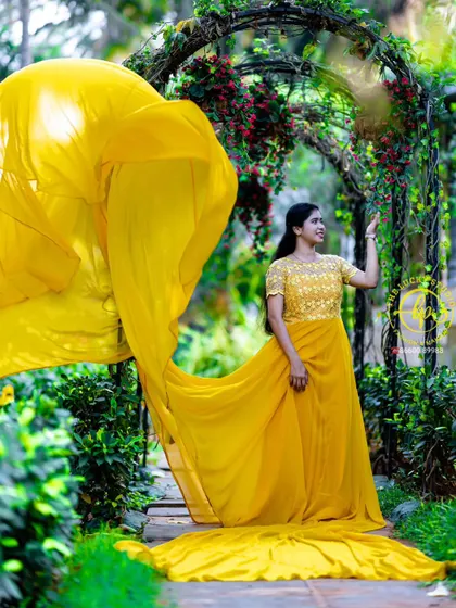 A solo portrait showcasing the beauty of the yellow gown and the intricate details on the bodice. The makeup is kept fresh and radiant to match the bright outfit.