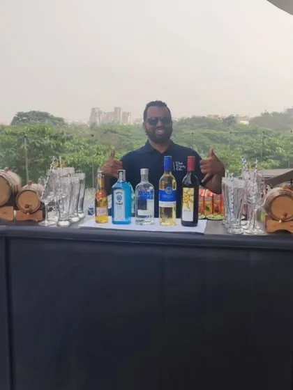 Our bartender ready for a brunch event on a rooftop. The setup includes mini barrels for aged cocktails, showing our range of specialty offerings.