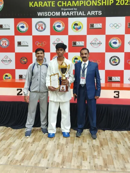 A student stands proudly with his trophy at the Bengaluru Open Karate Championship 2025. Individual victories contribute to the strength of our entire team.