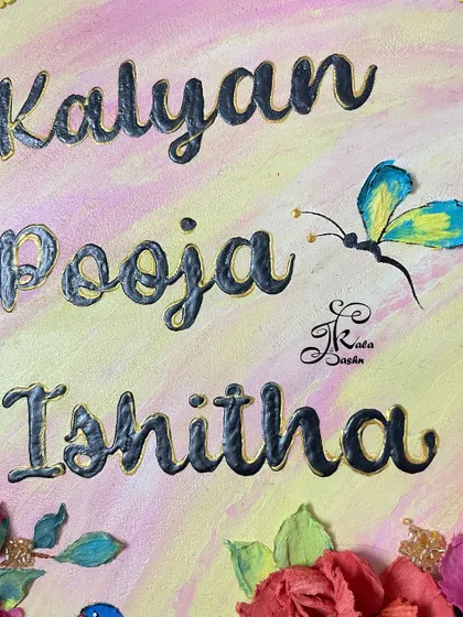 A close-up of the elegant script and a tiny sculpted butterfly on the family nameplate.