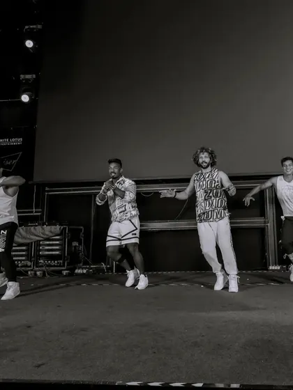 A black and white shot of the instructor team on stage. We work in sync to deliver a seamless and powerful performance for large audiences.