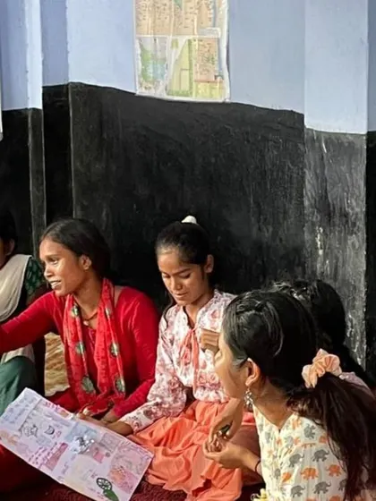 Laughter and stories being shared over a drawing. This candid moment captures the beautiful connections that were formed during the workshop. Art became the language through which we could share our experiences and understand each other.