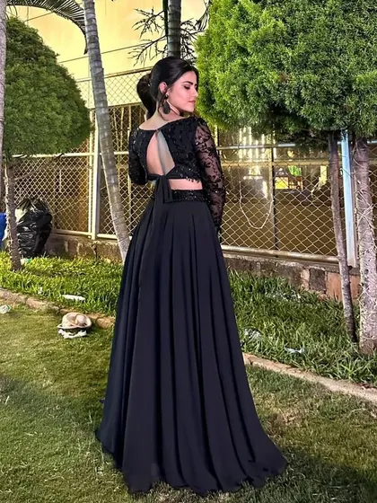 Actress Meghana in a chic all-black lehenga with a sheer embroidered crop top.
