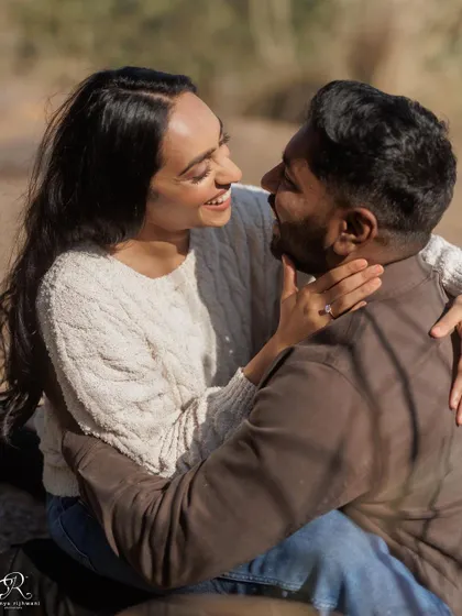 A playful and intimate moment from their engagement session. Her joyful expression and their close embrace make this a wonderfully candid and emotional photograph.