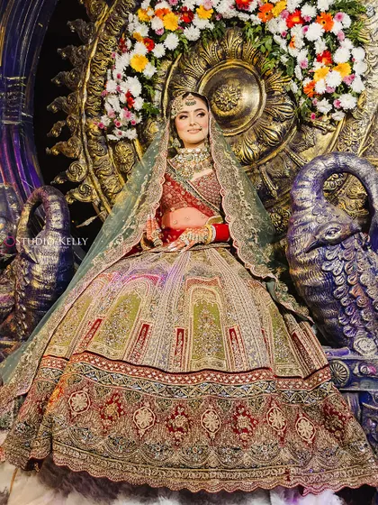 A grand bridal entry, with the bride seated on a magnificent, ornate throne, looking like a true queen.