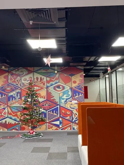 A wide shot of the office space with the Christmas tree, showing how a single element can transform the environment.