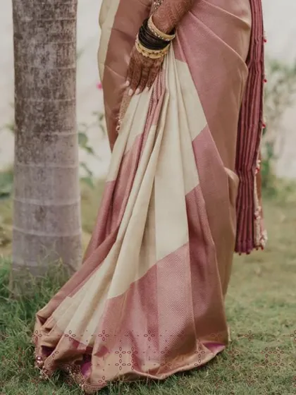 The luxurious fall of a custom designed Kanjivaram silk saree. The subtle sheen of the fabric and the traditional border are hallmarks of a timeless bridal piece.