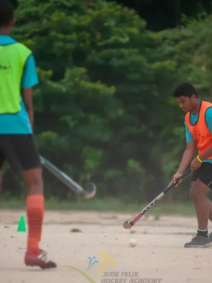 Two players from our 2022 camp work on a passing drill, demonstrating the importance of communication and teamwork.