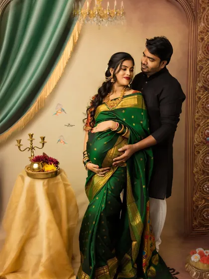 A regal portrait of an expecting couple. The rich green saree and traditional decor create a majestic feel, perfectly capturing the beauty of a twin pregnancy.