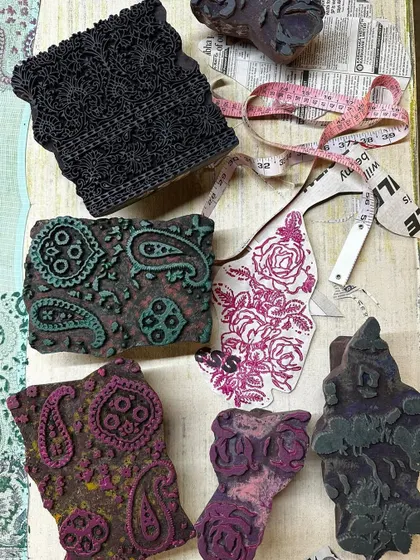 A flat lay showing the combination of vintage blocks and fabric swatches for a summer kota saree. We love mixing timeless floral and paisley prints to create a unique and dreamy aesthetic.